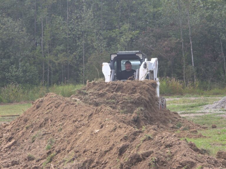 Skid steer loader operator at construction site